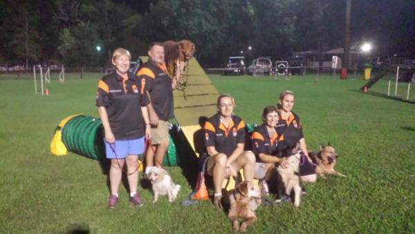 People posing with dogs and dog show